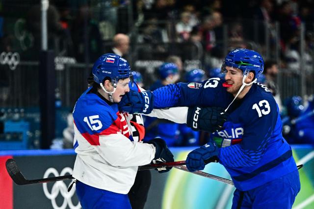 Slovakia's #15 Dalibor Dvorsky (L) fights with Italy's #13 Matt Bradley during the men's preliminary round Group B Ice Hockey match between Italy and Slovakia at the Milano Rho Ice Hockey Arena at the Milano Cortina 2026 Winter Olympic Games in Milan, on February 13, 2026. (Photo by JULIEN DE ROSA / AFP)