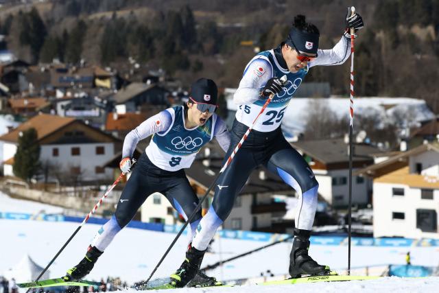 Japan's Daito Yamazaki (L) and Japan's Naoto Baba compete during the men's 10km cross-country interval start free event of the Milano Cortina 2026 Winter Olympic Games at Tesero Cross-Country Skiing Stadium in Lago di Tesero (Val di Fiemme) on February 13, 2026. (Photo by Anne-Christine POUJOULAT / AFP)