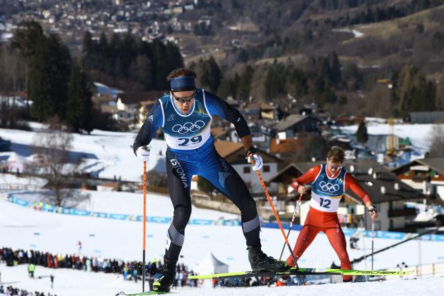 Estonia's Alvar Johannes Alev (L) and Switzerland's Nicola Wigger compete during the men's 10km cross-country interval start free event of the Milano Cortina 2026 Winter Olympic Games at Tesero Cross-Country Skiing Stadium in Lago di Tesero (Val di Fiemme) on February 13, 2026. (Photo by Anne-Christine POUJOULAT / AFP)