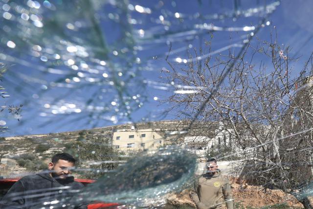 Palestinian men inspect one of several vehicles vandalised by Jewish settlers, who entered the Palestinian village of Telfit, south of the Israeli-occupied West Bank city of Nablus on February 13, 2026. The latest violence came days after Israel's security cabinet approved measures to tighten control over the West Bank, paving the way for further settlement expansion. Excluding Israeli-annexed east Jerusalem, more than 500,000 Israelis live in settlements and outposts across the West Bank, which are illegal under international law. (Photo by JAAFAR ASHTIYEH / AFP)