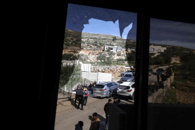 A shattered window overlooks a street after it was broken when Jewish settlers vandalised vehicles and homes in the Palestinian village of Telfit, south of the Israeli-occupied West Bank city of Nablus on February 13, 2026. The latest violence came days after Israel's security cabinet approved measures to tighten control over the West Bank, paving the way for further settlement expansion. Excluding Israeli-annexed east Jerusalem, more than 500,000 Israelis live in settlements and outposts across the West Bank, which are illegal under international law. (Photo by JAAFAR ASHTIYEH / AFP)