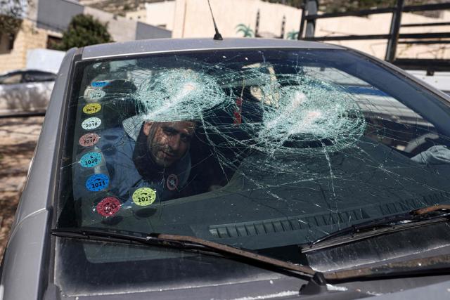 A Palestinian man inspects one of several cars vandalised by Jewish settlers, who entered the Palestinian village of Telfit, south of the Israeli-occupied West Bank city of Nablus on February 13, 2026. The latest violence came days after Israel's security cabinet approved measures to tighten control over the West Bank, paving the way for further settlement expansion. Excluding Israeli-annexed east Jerusalem, more than 500,000 Israelis live in settlements and outposts across the West Bank, which are illegal under international law. (Photo by JAAFAR ASHTIYEH / AFP)