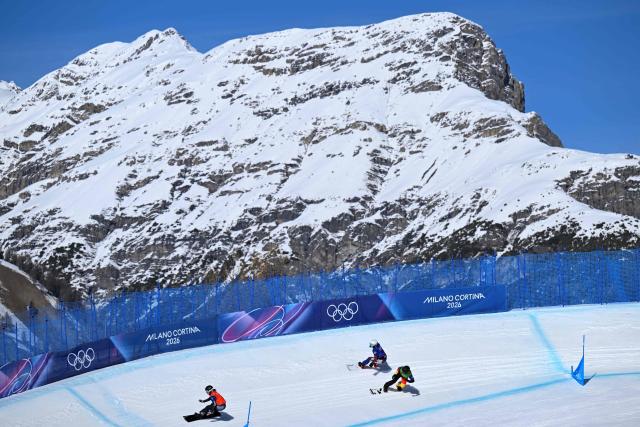 (L-R) Austria's Pia Zerkhold, Czech Republic's Karolina Hrusova and Germany's Jana Fischer compete in the snowboard women's cross 1/8 final 7 during the Milano Cortina 2026 Winter Olympic Games at Livigno Snow Park, in Livigno (Valtellina), on February 13, 2026. (Photo by Kirill KUDRYAVTSEV / AFP)