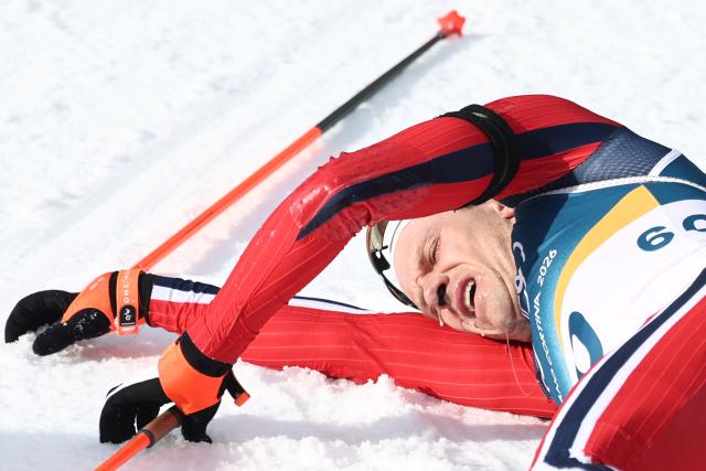 Norway's Vetle Sjaastad Christiansen lies in the snow after competing in the men's biathlon 10km sprint event during the Milano Cortina 2026 Winter Olympic Games at the Anterselva Biathlon Arena (Sudtirol Arena) in Anterselva (Val Pusteria) on February 13, 2026. (Photo by FRANCK FIFE / AFP)