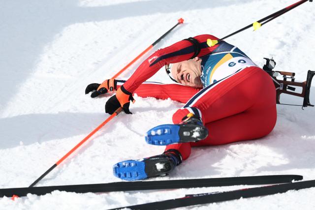 Norway's Vetle Sjaastad Christiansen lies in the snow after competing in the men's biathlon 10km sprint event during the Milano Cortina 2026 Winter Olympic Games at the Anterselva Biathlon Arena (Sudtirol Arena) in Anterselva (Val Pusteria) on February 13, 2026. (Photo by FRANCK FIFE / AFP)