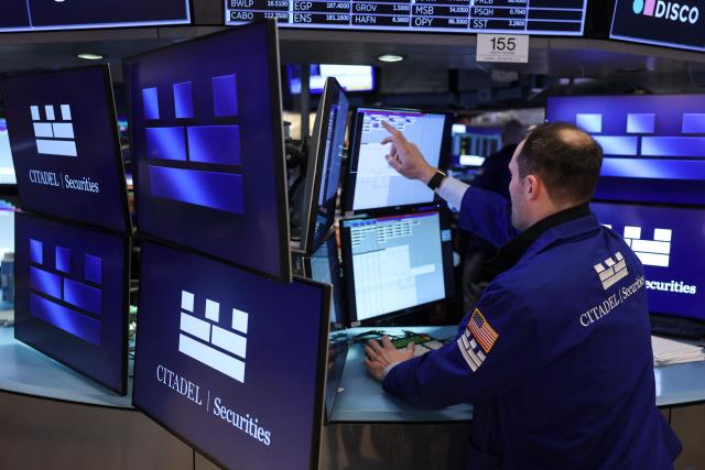 Traders works on the floor of the New York Stock Exchange (NYSE) at the opening bell on February 13, 2026  in New York City. Wall Street stocks moved sideways early Friday following the prior session's selloff after data showing US consumer inflation cooled a bit in December. (Photo by ANGELA WEISS / AFP)