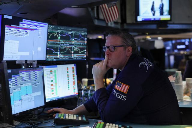 A trader works on the floor of the New York Stock Exchange (NYSE) at the opening bell on February 13, 2026  in New York City. Wall Street stocks moved sideways early Friday following the prior session's selloff after data showing US consumer inflation cooled a bit in December. (Photo by ANGELA WEISS / AFP)