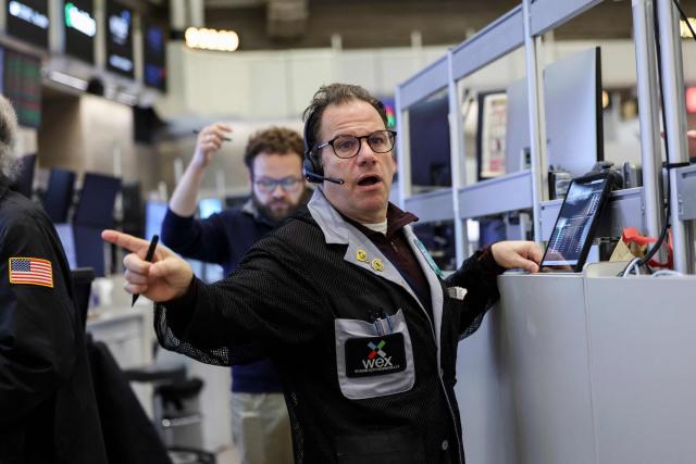 Traders works on the floor of the New York Stock Exchange (NYSE) at the opening bell on February 13, 2026  in New York City. Wall Street stocks moved sideways early Friday following the prior session's selloff after data showing US consumer inflation cooled a bit in December. (Photo by ANGELA WEISS / AFP)