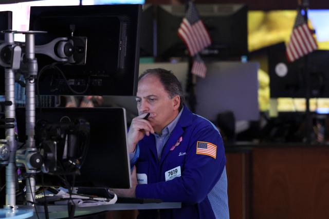 A trader works on the floor of the New York Stock Exchange (NYSE) at the opening bell on February 13, 2026  in New York City. Wall Street stocks moved sideways early Friday following the prior session's selloff after data showing US consumer inflation cooled a bit in December. (Photo by ANGELA WEISS / AFP)