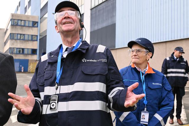 Electricite de France (EDF) Chairman and CEO Bernard Fontana (L), flanked by Arabelle Solutions' CEO Catherine Cornand, gestures during a visit to "Arabelle Solutions" nuclear power company in Belfort, eastern France on February 13, 2026. (Photo by SEBASTIEN BOZON / AFP)