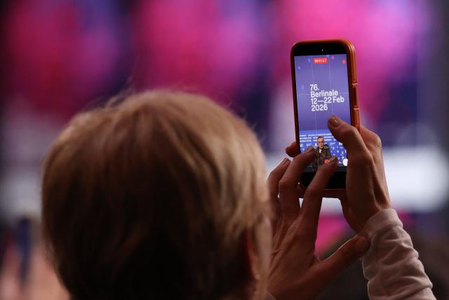 A person records Turkish actor Tansu Bicer (on display) with a mobile phone during a press conference for the film "Gelbe Briefe" (Yellow Letters) presented in competition at the 76th Berlinale, Europe's first major film festival of the year, in Berlin on February 13, 2026. (Photo by Ronny HARTMANN / AFP)