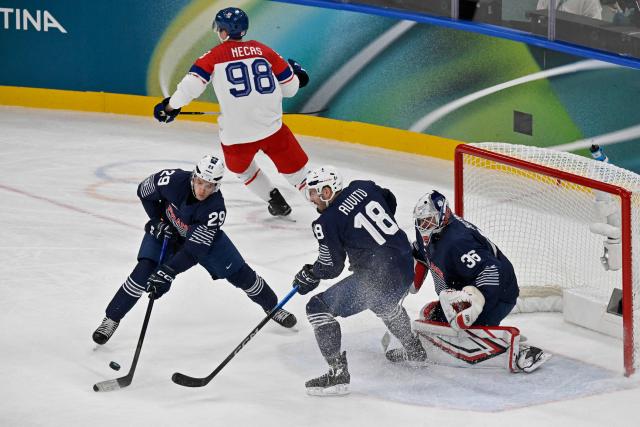 France's #29 Louis Boudon (L) and France's #18 Yohann Auvitu control the puck during men's preliminary round Group A Ice Hockey match between France and Czech Republic at the Milano Santagiulia Ice Hockey Arena during the Milano Cortina 2026 Winter Olympic Games in Milan, on February 13, 2026. (Photo by Alexander NEMENOV / AFP)