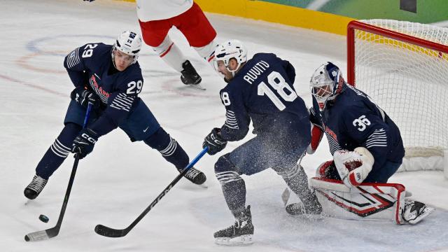 France's #29 Louis Boudon (L) and France's #18 Yohann Auvitu control the puck during men's preliminary round Group A Ice Hockey match between France and Czech Republic at the Milano Santagiulia Ice Hockey Arena during the Milano Cortina 2026 Winter Olympic Games in Milan, on February 13, 2026. (Photo by Alexander NEMENOV / AFP)