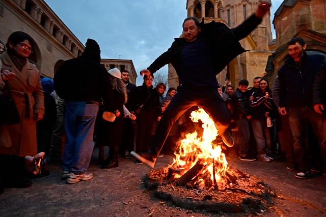Christian Armenians celebrate Trndez, a feast of purification, in front of St. Anna Church in Yerevan on February 13, 2026. Trndez, now celebrated as a Christian feast, has pagan origins and in ancient pre-Christian Armenia was associated with the worship of Vahagn, the god of Fire and Sun, and celebrated as nature awakening festival. Couples, especially newlyweds, jump over the Trndez bonfire believing it will bring luck and prosperity to them. (Photo by KAREN MINASYAN / AFP)