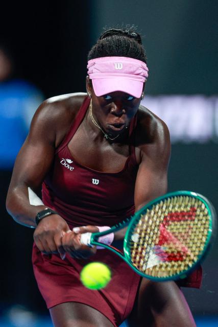 Canada's Victoria Mboko hits a return to Latvia's Jelena Ostapenko during their women’s singles semi-final match at the Qatar Open tennis tournament in Doha on February 13, 2026. (Photo by Karim JAAFAR / AFP)
