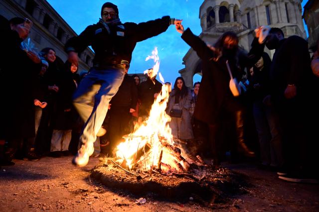 Christian Armenians celebrate Trndez, a feast of purification, in front of St. Anna Church in Yerevan on February 13, 2026. Trndez, now celebrated as a Christian feast, has pagan origins and in ancient pre-Christian Armenia was associated with the worship of Vahagn, the god of Fire and Sun, and celebrated as nature awakening festival. Couples, especially newlyweds, jump over the Trndez bonfire believing it will bring luck and prosperity to them. (Photo by KAREN MINASYAN / AFP)