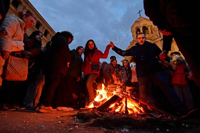 Christian Armenians celebrate Trndez, a feast of purification, in front of St. Anna Church in Yerevan on February 13, 2026. Trndez, now celebrated as a Christian feast, has pagan origins and in ancient pre-Christian Armenia was associated with the worship of Vahagn, the god of Fire and Sun, and celebrated as nature awakening festival. Couples, especially newlyweds, jump over the Trndez bonfire believing it will bring luck and prosperity to them. (Photo by KAREN MINASYAN / AFP)