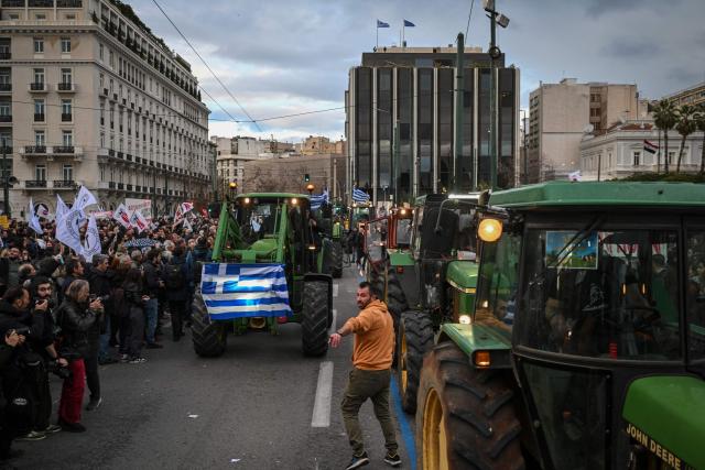 Greek farmers take part with their tractors in a protest over long delays in subsidy payments, low prices, rising energy costs and worsening climate conditions, outside the parliament in Athens on February 13, 2026. (Photo by Aris MESSINIS / AFP)