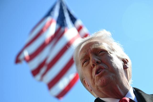 US President Donald Trump speaks to the media as he walks to board Marine One prior to departure from the South Lawn of the White House in Washington, DC, on February 13, 2026. (Photo by ANDREW CABALLERO-REYNOLDS / AFP)