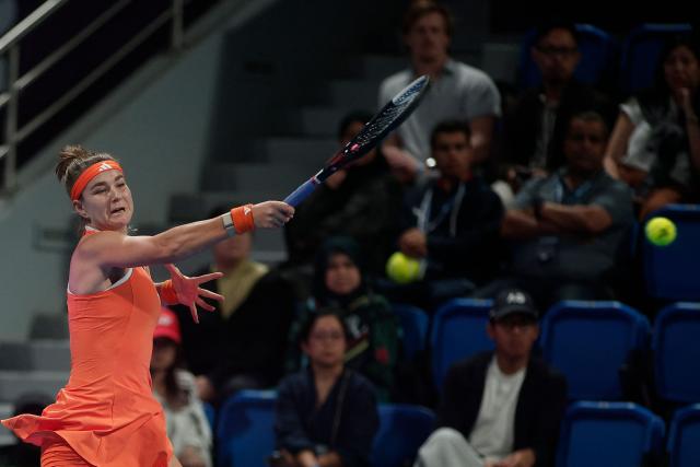 Czech Republic's Karolina Muchova hits a return against Greece's Maria Sakkari during their women’s singles semi-final match at the Qatar Open tennis tournament in Doha on February 13, 2026. (Photo by Karim JAAFAR / AFP)