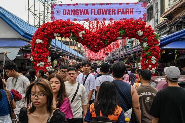 (FILES) People visit a market ahead of Valentine's Day in Manila on February 13, 2026. In the run-up to this year's Valentine's Day on February 14, 2026, romantics from Paris to Lagos and in the ongoing Olympic Games, are preparing to celebrate the Roman Saint Valentine whose feast day has since the Middle Ages been associated with courting couples. (Photo by Jam STA ROSA / AFP)