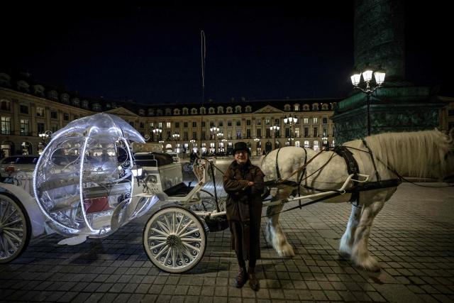 (FILES) Coach driver Philippe Delon poses in front of a Cinderella carriage in Paris on February 7, 2026, prior to Saint Valentine's day. In the run-up to this year's Valentine's Day on February 14, 2026, romantics from Paris to Lagos and in the ongoing Olympic Games, are preparing to celebrate the Roman Saint Valentine whose feast day has since the Middle Ages been associated with courting couples. (Photo by STEPHANE DE SAKUTIN / AFP)
