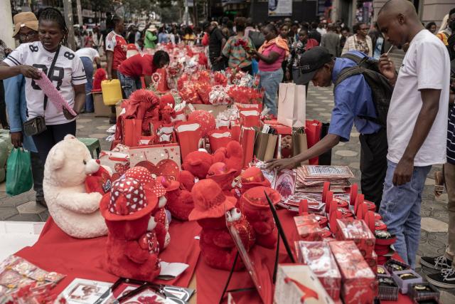 Pedestrians choosing what to buy as vendors sell Valentine Day gifts in downtown Nairobi, on February 13, 2026. (Photo by SIMON MAINA / AFP)