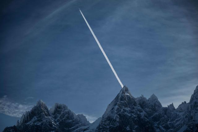 This photograph shows a commercial aircraft flying over the Massif du Mont-Blanc mountain range in the French Alps, near Chamonix on February 13, 2026. (Photo by OLIVIER CHASSIGNOLE / AFP)