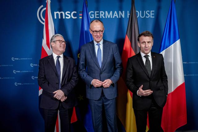 (L-R) British Prime Minister Keir Starmer, German Chancellor Friedrich Merz and France’s President Emmanuel Macron pose for a photo at the start of the E-3 meeting, during the Munich Security Conference, on February 13, 2026 in Munich. Heads of state and government as well as foreign and defence ministers from all over the world are expected to attend the security policy talks from February 13 to 15, 2026. (Photo by Kay Nietfeld / POOL / AFP)