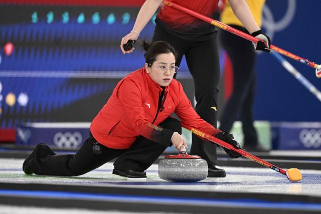 Wang Rui of China competes in the curling women's round robin between China and Switzerland during the Milano Cortina 2026 Winter Olympic Games at the Cortina Curling Olympic Stadium in Cortina d’Ampezzo on February 13, 2026. (Photo by Tiziana FABI / AFP)