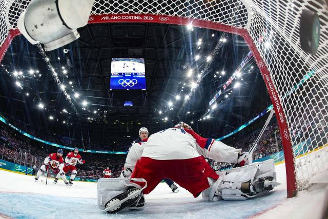 France's #29 Louis Boudon (L) reacts after scoring a goal past Czech Republic's #80 Daniel Vladar (R) during men's preliminary round Group A Ice Hockey match between France and Czech Republic at the Milano Santagiulia Ice Hockey Arena during the Milano Cortina 2026 Winter Olympic Games in Milan, on February 13, 2026. (Photo by POOL / AFP)