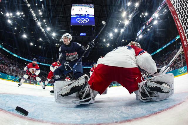 France's #29 Louis Boudon (L) reacts after scoring a goal past Czech Republic's #80 Daniel Vladar (R) during men's preliminary round Group A Ice Hockey match between France and Czech Republic at the Milano Santagiulia Ice Hockey Arena during the Milano Cortina 2026 Winter Olympic Games in Milan, on February 13, 2026. (Photo by POOL / AFP)