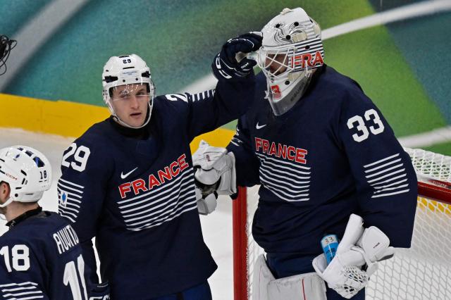France's #29 Louis Boudon (L) and France's #33 Julian Junca react after losing men's preliminary round Group A Ice Hockey match between France and Czech Republic at the Milano Santagiulia Ice Hockey Arena during the Milano Cortina 2026 Winter Olympic Games in Milan, on February 13, 2026. (Photo by Alexander NEMENOV / AFP)
