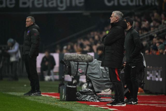 Paris Saint-Germain's Spanish headcoach Luis Enrique (L) and Rennes' French interim head coach Sebastien Tambouret (R) look on during the French L1 football match between Stade Rennais FC and Paris Saint-Germain (PSG) at the Roazhon Park stadium in Rennes, western France, on February 13, 2026. (Photo by Damien MEYER / AFP)