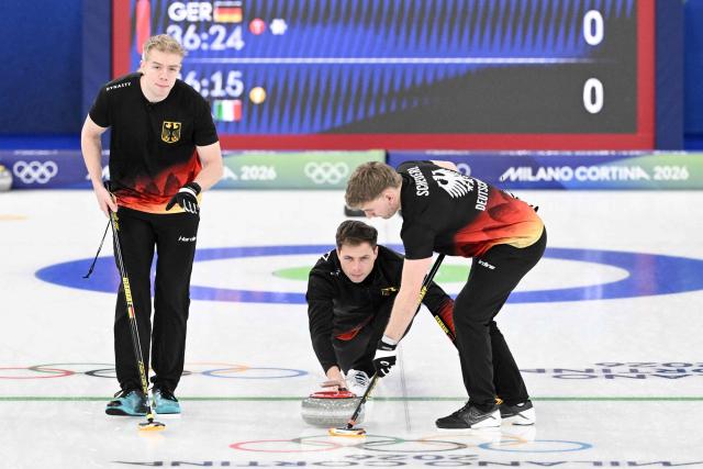 (LtoR) Germany's Felix Messenzehl, Germany's Marc Muskatewitz and Germany's Johannes Scheuerl compete in the curling men's round robin between Germany and Italy during the Milano Cortina 2026 Winter Olympic Games at the Cortina Curling Olympic Stadium in Cortina d’Ampezzo on February 13, 2026. (Photo by Tiziana FABI / AFP)