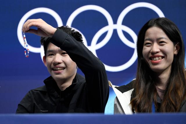 Taiwan's Li Yu-Hsiang react in the kiss and cry area after competing in the figure skating men's singles free skating final during the Milano Cortina 2026 Winter Olympic Games at Milano Ice Skating Arena in Milan on February 13, 2026. (Photo by WANG Zhao / AFP)