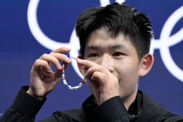Taiwan's Li Yu-Hsiang react in the kiss and cry area after competing in the figure skating men's singles free skating final during the Milano Cortina 2026 Winter Olympic Games at Milano Ice Skating Arena in Milan on February 13, 2026. (Photo by WANG Zhao / AFP)