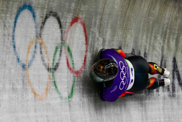 China's Lin Qinwei competes in the skeleton men's heat 3 at Cortina Sliding Centre during the Milano Cortina 2026 Winter Olympic Games in Cortina d'Ampezzo on February 13, 2026. (Photo by Stefano RELLANDINI / AFP)