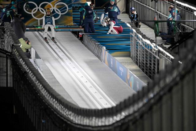 Germany's Philipp Raimund prepares to slide down the inrun track during the training for the men's large hill ski jumping of the Milano Cortina 2026 Winter Olympic Games at Predazzo Ski Jumping Stadium in Predazzo (Val di Fiemme), on February 13, 2026. (Photo by Tobias SCHWARZ / AFP)