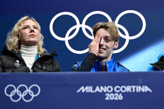 Estonia's Aleksandr Selevko (R) reacts in the kiss and cry area after competing in the figure skating men's singles free skating final during the Milano Cortina 2026 Winter Olympic Games at Milano Ice Skating Arena in Milan on February 13, 2026. (Photo by WANG Zhao / AFP)