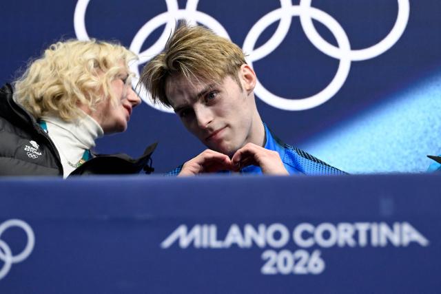 Estonia's Aleksandr Selevko (R) reacts in the kiss and cry area after competing in the figure skating men's singles free skating final during the Milano Cortina 2026 Winter Olympic Games at Milano Ice Skating Arena in Milan on February 13, 2026. (Photo by WANG Zhao / AFP)