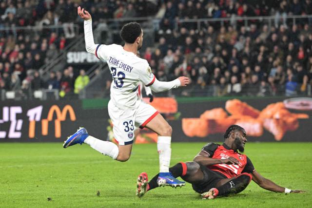 Paris Saint-Germain's French midfielder #33 Warren Zaire-Emery (L) and Rennes' French defender #03 Lilian Brassier fight for the ball during the French L1 football match between Stade Rennais FC and Paris Saint-Germain (PSG) at the Roazhon Park stadium in Rennes, western France, on February 13, 2026. (Photo by Damien MEYER / AFP)
