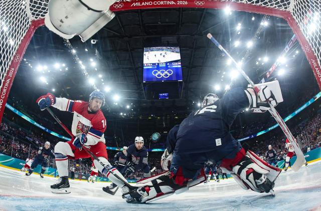 Czech Republic's #14 Filip Chlapik (L) scores a goal past France's #36 Martin Neckar  during men's preliminary round Group A Ice Hockey match between France and Czech Republic at the Milano Santagiulia Ice Hockey Arena during the Milano Cortina 2026 Winter Olympic Games in Milan, on February 13, 2026. (Photo by POOL / AFP)