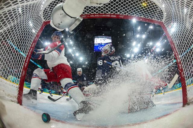 Czech Republic's #14 Filip Chlapik (L) scores a goal past France's #36 Martin Neckar  during men's preliminary round Group A Ice Hockey match between France and Czech Republic at the Milano Santagiulia Ice Hockey Arena during the Milano Cortina 2026 Winter Olympic Games in Milan, on February 13, 2026. (Photo by POOL / AFP)