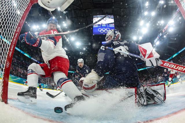 Czech Republic's #14 Filip Chlapik (L) scores a goal past France's #36 Martin Neckar  during men's preliminary round Group A Ice Hockey match between France and Czech Republic at the Milano Santagiulia Ice Hockey Arena during the Milano Cortina 2026 Winter Olympic Games in Milan, on February 13, 2026. (Photo by POOL / AFP)
