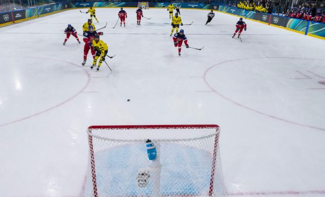 Sweden's #08 Hilda Svensson (L) shoots and scores her team second goal during the women's quarter final Ice Hockey match between Czech Republic and Sweden at the Milano Rho Ice Hockey Arena at the Milano Cortina 2026 Winter Olympic Games in Milan, on February 13, 2026. (Photo by Wang Kaiyan / POOL / AFP)
