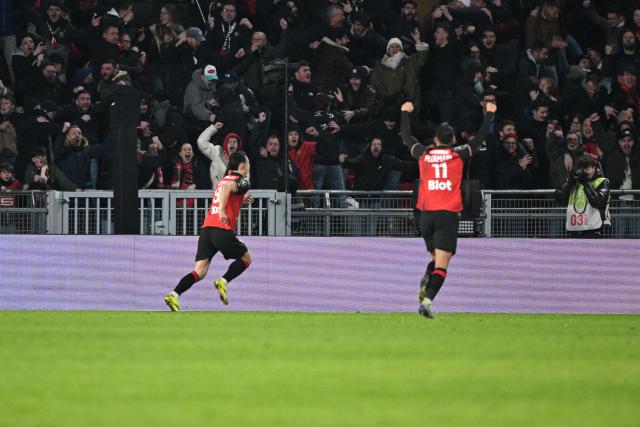 Rennes' French forward #09 Esteban Lepaul (L) celebrates scoring his team's second goal during the French L1 football match between Stade Rennais FC and Paris Saint-Germain (PSG) at the Roazhon Park stadium in Rennes, western France, on February 13, 2026. (Photo by Damien MEYER / AFP)