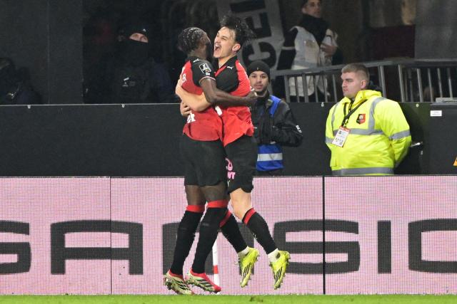 CORRECTION / Rennes' French forward #09 Esteban Lepaul#24 Anthony Rouault (R) celebrates after scoring his team's second goal during the French L1 football match between Stade Rennais FC and Paris Saint-Germain (PSG) at the Roazhon Park stadium in Rennes, western France, on February 13, 2026. (Photo by Damien MEYER / AFP) / The erroneous mention[s] appearing in the metadata of this photo by Damien MEYER has been modified in AFP systems in the following manner: [Rennes' French  forward #09 Esteban Lepaul] instead of [Rennes' French defender #24 Anthony Rouault]. Please immediately remove the erroneous mention[s] from all your online services and delete it (them) from your servers. If you have been authorized by AFP to distribute it (them) to third parties, please ensure that the same actions are carried out by them. Failure to promptly comply with these instructions will entail liability on your part for any continued or post notification usage. Therefore we thank you very much for all your attention and prompt action. We are sorry for the inconvenience this notification may cause and remain at your disposal for any further information you may require.