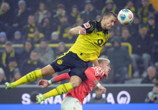 Dortmund's German defender #03 Waldemar Anton and Mainz' German forward #20 Phillip Tietz vie for the ball during the German first division Bundesliga football match between Borussia Dortmund and Mainz 05 in Dortmund, western Germany, on February 13, 2026. (Photo by Sascha Schuermann / AFP) / DFL REGULATIONS PROHIBIT ANY USE OF PHOTOGRAPHS AS IMAGE SEQUENCES AND/OR QUASI-VIDEO