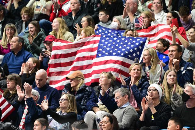 USA supporters cheer from the stands during the figure skating men's singles free skating final during the Milano Cortina 2026 Winter Olympic Games at Milano Ice Skating Arena in Milan on February 13, 2026. (Photo by Piero CRUCIATTI / AFP)